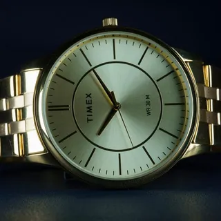 A gold-tone Timex watch on a link bracelet